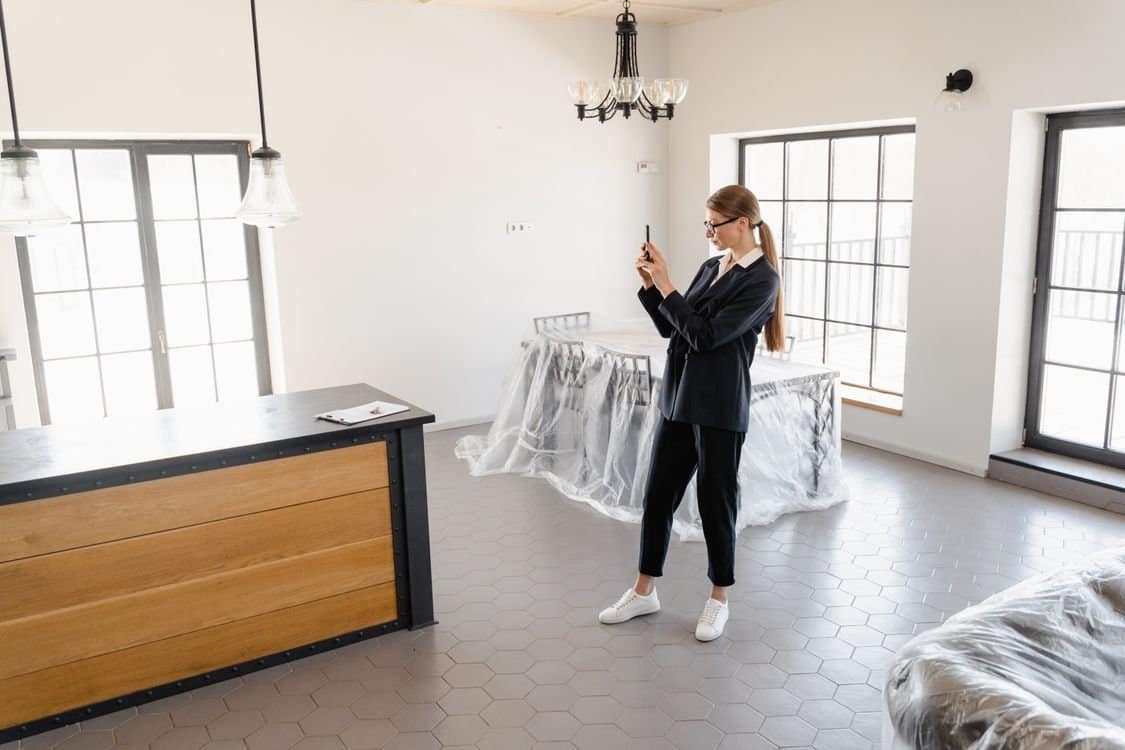 Professional taking photographs of a bright residential interior